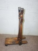 A 19th century boot jack, with turned supports and hinged boot 'lock', 78cm high