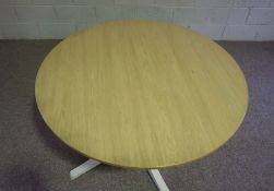 An Ercol ash topped circular dining table, model number: 1423BNP, the top on a painted box section