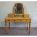 A Victorian ash dressing table, circa 1900, with a mirror and arrangement of drawers, on turned