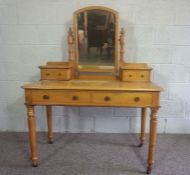 A Victorian ash dressing table, circa 1900, with a mirror and arrangement of drawers, on turned