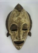 An African tribal carved and painted mask (or death mask), 37cm high, 20th century