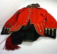 A Sergeant's dress uniform of the King's Own Scottish Borderers, including a red tunic, sash, trews,