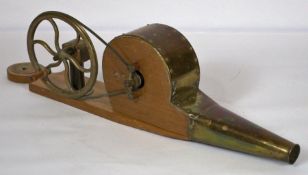 A vintage brass hand wound bellows, on wooden base, 60cm long; together with a small oak pipe rack