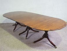 A George III style mahogany triple pillar extending dining table, 20th century, with two D ends