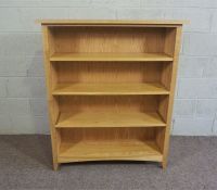 A modern ash open bookcase, with three adjustable shelves, 126cm high, 110cm wide; together with a