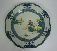 A large Chinese famille verte and blue and white charger, Qing Dynasty, the lobed dished plate