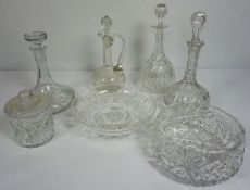 A large assortment of table glassware, including a claret jug, three decanters and a set of assorted