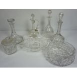 A large assortment of table glassware, including a claret jug, three decanters and a set of assorted