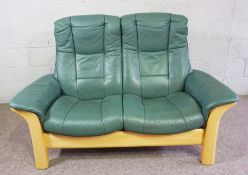 A modern Ekornes green leather two seat settee, with adjustable back, 150cm wide; together with a
