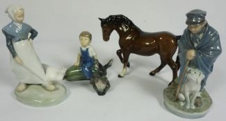 A group of porcelain figures, including a Royal Copenhagen figure of boy sitting on a marrow; also a