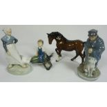 A group of porcelain figures, including a Royal Copenhagen figure of boy sitting on a marrow; also a