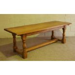 A large oak Jacobean style refectory dining table, modern, 20th century, with a plain planked top on