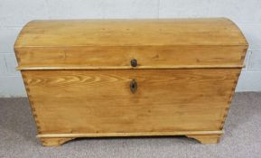 A large pine dome topped chest, with canted sides and loop side handles, 84cm high, 130cm wide