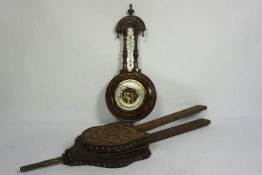 A late Victorian aneroid barometer and thermometer, in an carved case; together with a pair of oak