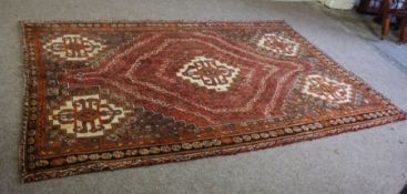 A Caucasian Kazak rug, 20th century, with stylised medallions on a red brown ground, 260cm x 160cm
