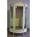 A large vintage shops display cabinet, currently painted (probably mahogany and related to the other