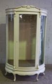 A large vintage shops display cabinet, currently painted (probably mahogany and related to the other