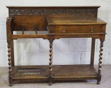 An early 20th century oak hall stand, with twist column supports, a single drawer and offset stick