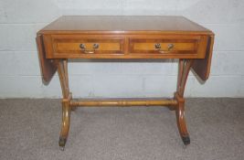 A Regency style yew veneered sofa table, 20th century, 76cm high, 92cm wide (closed); together