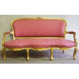 A George III style giltwood framed settee (or Canap‚), 20th century revival, with an arched