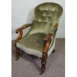 A Victorian mahogany framed button upholstered spoon-backed armchair, currently upholstered in
