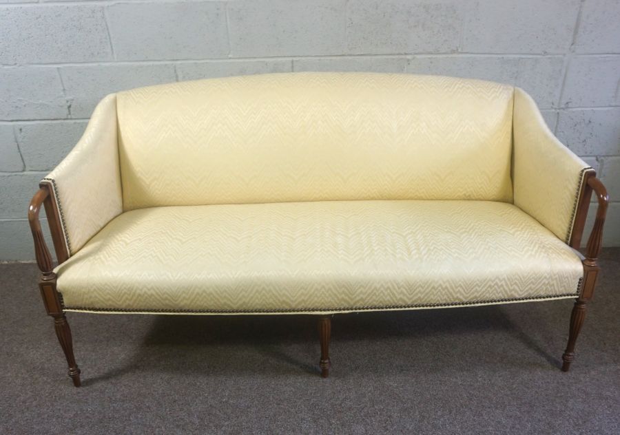 A George III style mahogany canap‚ (or settee), 20th century, currently upholstered in yellow