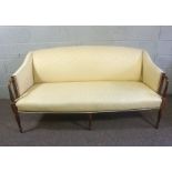 A George III style mahogany canap‚ (or settee), 20th century, currently upholstered in yellow