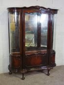 A modern Victorian style 'mahogany' and glazed display cabinet, late 20th century, with two glass