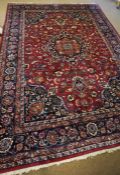 A large Persian wool rug, late 20th century, decorated with multiple flower heads on a light and
