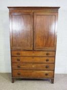 A 19th century mahogany linen press, with moulded cornice over two panelled doors, opening to