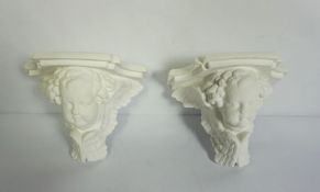 A pair of modern plaster wall shelves with winged putti supporters, 17cm high (2)