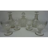 A pair of early 19th century glass mallet decanters, together with a set of four rummers, with