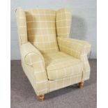 A Yellow and cream check upholstered wing armchair, modern, 111cm high; together with a pair of