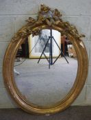 A 19th century composition gilt framed oval wall mirror, with foliate decoration, losses, 100cm