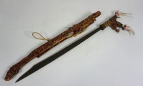 An Indonesian decorative sword and scabbard, with carved figures, modern, 82cm long
