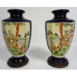 A pair of Japanese export baluster vases, circa 1900, decorated with panels with figures on a blue