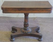 A George IV rosewood card table, circa 1825, with a rotating rounded fold-over top, opening to
