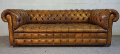 A vintage leather button backed Chesterfield Sofa, with nicely worn in brown leather seat, 77cm
