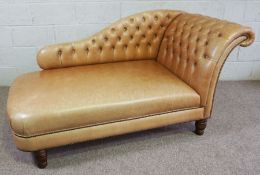A leather button backed chaise longue, 20th century, with a deep seat and turned feet, 85cm high,