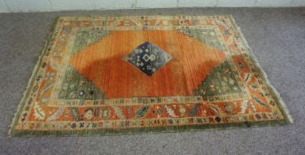 A modern Caucasian style rug, with central lozenge on orange ground, 183cm by 140cm; together with a