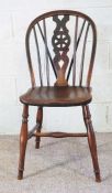 A selection of provincial chairs, including an ash framed wheel backed dining chair; a set of
