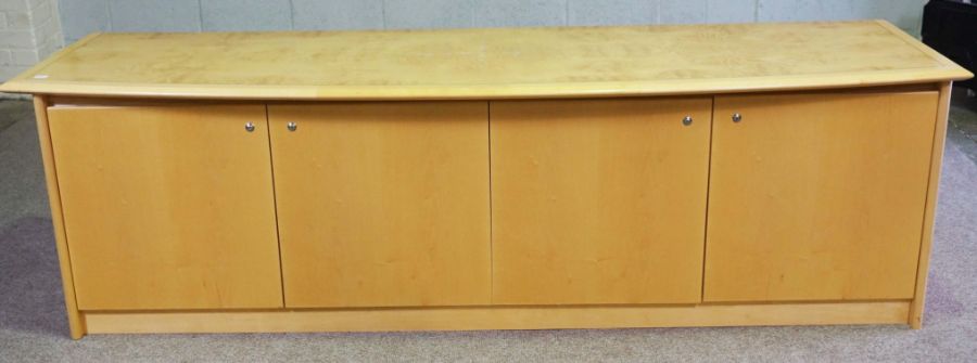 A modern bow-front credenza or serving cabinet, by Hands of Wycombe, circa 2000, with a burr