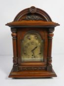 An early 20th century Germany bracket clock, with chiming movement, in a walnut arched case, 47cm