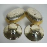 Two silver capstan inkwells, both hallmarked Birmingham, marks rubbed, of typical form, one with