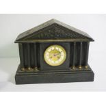 A Victorian slate cased mantel clock, with classical architectural detail, with six columns,