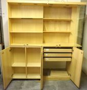 A large modular cherry veneered shop display cabinet, with glazed top, shelving and a base with