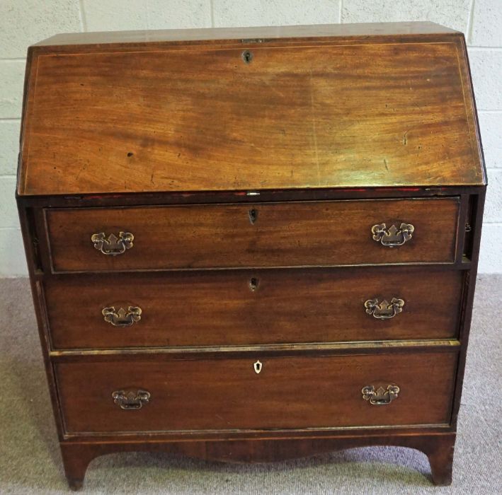 A George III mahogany bureau, late 18th century, with a fall front opening to reveal a fitted