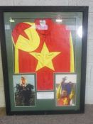 Grand National Interest: A framed racing silk, signed by Richard Dunwoody, the red and yellow ‘silk’