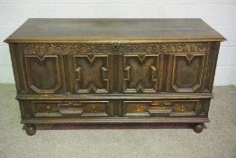 A William III oak coffer, early 18th century, the geometric panelled front inscribed ‘K.B 1701’,