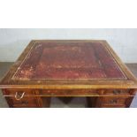 A George III style mahogany partners desk, early 20th century, with a wide leathered and moulded